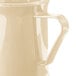 A close-up of a beige Cambro polycarbonate coffee mug with a handle.