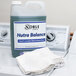 A bottle of Noble Chemical Nutra Balance laundry neutralizer on a washing machine next to a towel.
