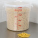 A translucent Cambro round polypropylene food storage container filled with noodles.