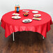 A red Hoffmaster Cellutex table cover on a table with food.