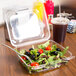A salad in a clear plastic take-out container.