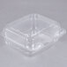 A Durable Packaging clear hinged plastic take-out container with a lid.
