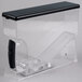 A clear plastic container with a black handle.