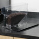 A Bunn Smart Hopper filled with coffee beans on a counter.