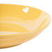 A close up of a yellow GET Diamond Mardi Gras tropical yellow melamine bowl.