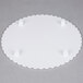 A white Wilton round scalloped edge cake separator plate with three small plastic holes.