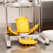 A Nemco pineapple corer and peeler machine with a piece of pineapple on it.