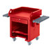A red Cambro Versa cart with shelves and tray rails.