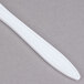 A close up of a Dart white plastic knife.