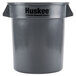 A grey Continental Huskee 10 gallon round trash can with black text on the side.