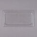 A clear plastic Cambro 1/3 size food pan lid on a clear plastic container.