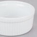 A CAC white ceramic fluted souffle bowl with a white rim.