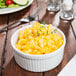 A white fluted bowl filled with macaroni and cheese.