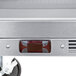 The stainless steel top of a Beverage-Air worktop refrigerator with a grill over two drawers.