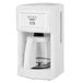 A white STAY by Cuisinart coffee maker with a glass pot and silver accents.