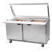 A Beverage-Air stainless steel refrigerated sandwich prep table with glass lids.