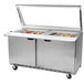 A Beverage-Air stainless steel sandwich prep table with glass lid over two trays.