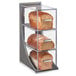 A Cal-Mil Ashwood bread display case with three loaves of bread inside.