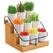 A Cal-Mil bamboo coffee condiment station with white containers full of vegetables.