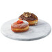 A plate of two donuts on a Cal-Mil marble melamine tray.