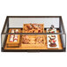 A Cal-Mil pastry drawer display case filled with pastries on a table.