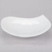 A CAC bone white porcelain peach plate with a curved edge.