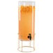 A Cal-Mil plastic beverage dispenser with orange juice and orange slices on it.
