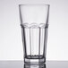 An Arcoroc clear glass with a rim on top.