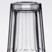 An Arcoroc clear glass with a clear base and a black rim.
