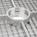 A stainless steel Hobart dicing grid with a hole in it.