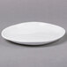 An American Metalcraft Crave melamine plate with a small rim on a gray surface.