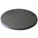 A Holland Bar Stool EnduroTop round table top in charcoal on a round wooden table.