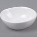 An American Metalcraft white melamine fruit bowl on a gray surface.