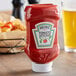 A Heinz upside down bottle of ketchup on a table.