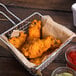 A basket of Pierce Chicken Hot and Spicy Breaded Chicken Wing-Zings.