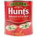 A can of Hunt's Premium tomato ketchup with a tomato on the label.