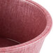 A close up of a pink plastic ramekin with a lid.