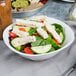 A bowl of salad with Tyson grilled chicken strips.
