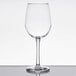 A clear Libbey Vina wine glass on a reflective surface.
