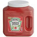 A plastic container of Heinz tomato ketchup with a white lid.
