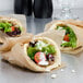 A wrapped sandwich with Kronos Traditional Gyros slices in pita bread.