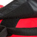A close up of a red and black Rubbermaid ProServe insulated pizza delivery bag.