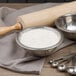 A silver bowl of Ardent Mills Occident Bakers Short Patent Flour with a rolling pin.