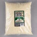 A package of Cucina Andolina 5 lb. Grated Parmesan Cheese on a gray surface.