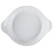 A white china shirred egg dish with handles.