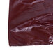 A close-up of a 1/6 size brown plastic T-shirt bag with a zipper.