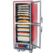 A red and silver Metro C5 holding and proofing cabinet with trays of food inside.