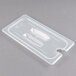 A translucent plastic lid with white handles and a spoon notch on a plastic food container.