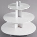 A white three tiered Enjay cupcake stand.