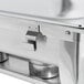 A stainless steel Choice chafer with metal handles on a folding stand.